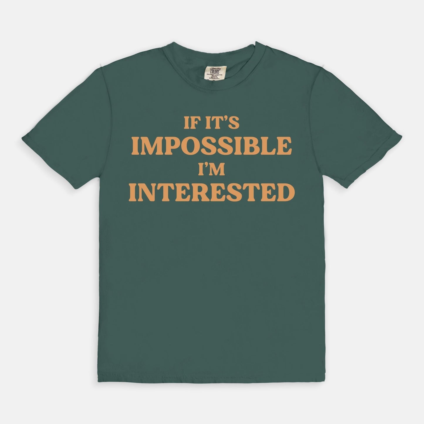 Shop the If It's Impossible I'm Interested T-Shirt in Blue Spruce. Free shipping. Buy today at Up & Comer!